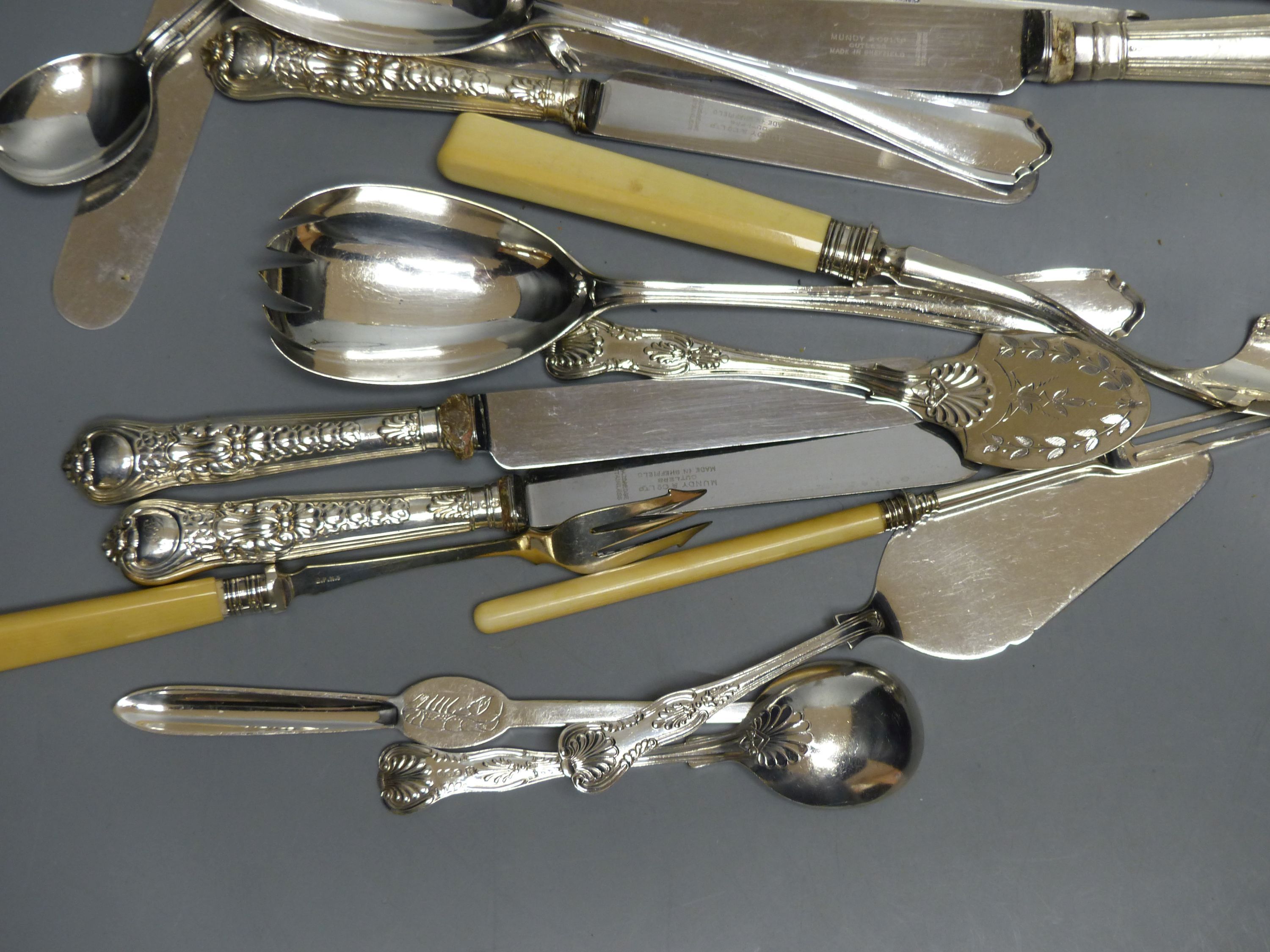 A small collection of silver and plated flatware, including a pair of silver Kings pattern jam spoons,